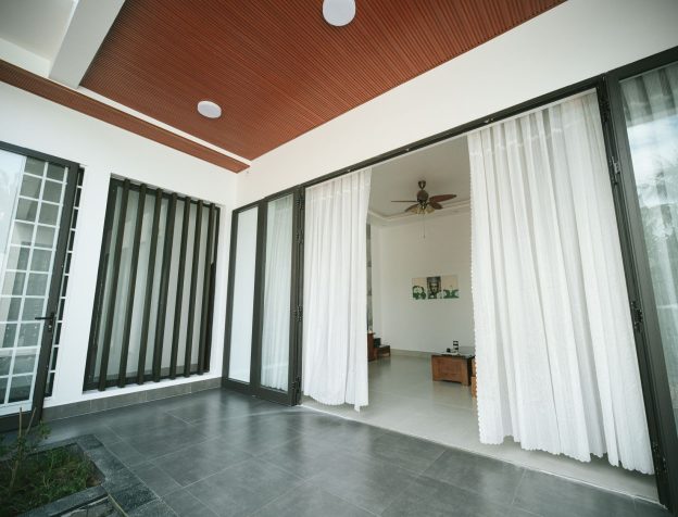 Không gian phòng khách rộng rãi, nhiều ánh sáng tự nhiên và cửa sổ lớn mở ra bên ngoài